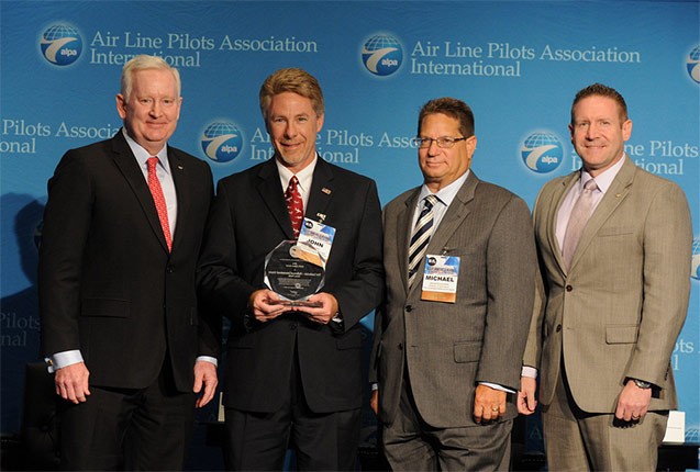 Captain Canoll presents the 2014 Airport Award to representatives from the Fort Lauderdale - Hollywood International Airport